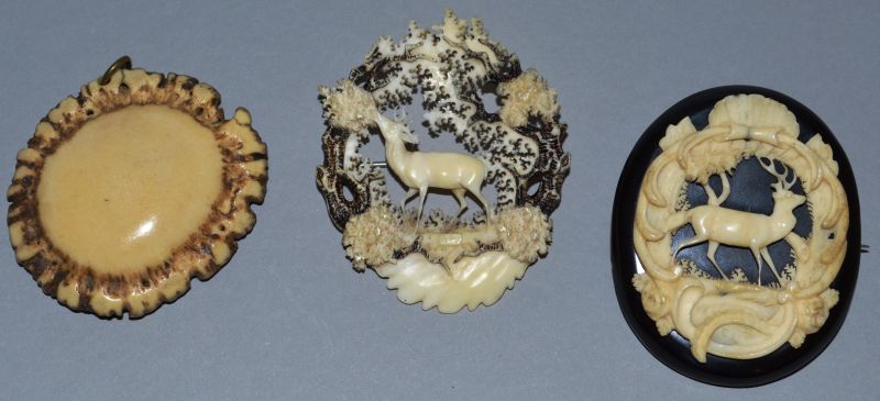 THREE SCOTTISH CARVED IVORY BROOCHES.