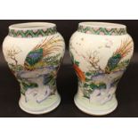 AN UNUSUAL PAIR OF 18TH CENTURY CHINESE FAMILLE ROSE PORCELAIN VASES, each painted with a pair of