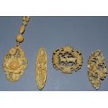 AN IVORY CHAIN AND PENDANT AND THREE BROOCHES.