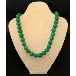 A CHINESE GREEN JADE-LIKE NECKLACE, composed of spherical beads, approx. 22.5in long.