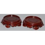 A PAIR OF CHINESE HARDWOOD CIRCULAR STANDS. 5ins diameter.