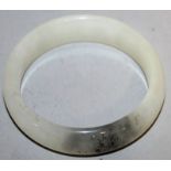 A CHINESE WHITE JADE BANGLE, 2.7in diameter.