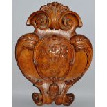 A LARGE 18TH CENTURY FRENCH CARVED WOOD PLAQUE, a carved lion with scrolls. 22ins long.