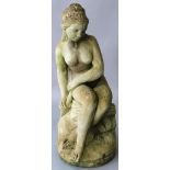 A RECONSTITUTED STONE FIGURE OF A SEATED FEMALE NUDE. 2ft high.