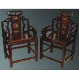 A PAIR OF CHINESE REDWOOD ARM CHAIRS, with pierced tops and three gilt panels to the back, and