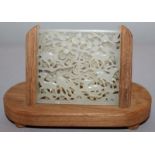 A CHINESE CARVED & PIERCED WHITE JADE TABLET, together with a wood display stand, the rectangular