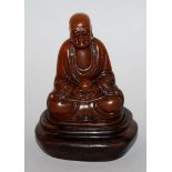 A SMALL GOOD QUALITY CHINESE SOAPSTONE FIGURE OF A LOHAN, together with a fitted wood stand, the