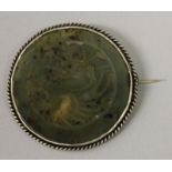 AN EARLY 20TH CENTURY CHINESE JADE-LIKE BROOCH, with a metal mount, 2.3in diameter; together with