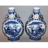 A PAIR OF 19TH CENTURY CHINESE BLUE & WHITE PORCELAIN MOON FLASKS, each painted with panels of