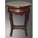 A 19TH CENTURY CHINESE HARDWOOD SHAPED OVAL-TOP STAND, on four curving legs with uniting stretchers,