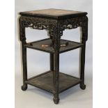 AN EARLY 20TH CENTURY CHINESE CARVED HARDWOOD MARBLE-TOP THREE TIER STAND, with carved key-fret