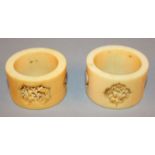 A NEAR PAIR OF 19TH CENTURY CHINESE CANTON IVORY NAPKIN RINGS, 1.8in & 1.9in diameter.