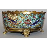 A 19TH CENTURY FRENCH ORMOLU MOUNTED AND CHAMPLEVE ENAMEL OVAL DISH supported on four curving legs