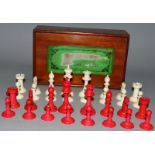 AN IVORY AND RED STAINED IVORY CHESS SET.