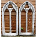 A PAIR OF RECONSTITUTED STONE GOTHIC WINDOW STYLE GARDEN ORNAMENTS. 2ft 7ins high.