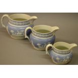 A 19TH CENTURY SPODE GRADUATED SET OF THE JUGS with applied classical scenes.