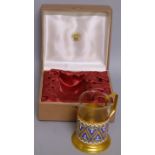A RUSSIAN GILT AND ENAMEL MUG with glass liner, in original box.