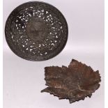 A RUSSIAN CAST IRON CIRCULAR PIERCED DISH AND A LEAF DISH 8ins and 7ins.