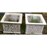 A PAIR OF RECONSTITUTED STONE SQUARE SHAPE PLANTERS of stylised lattice work design. 1ft 3ins high.