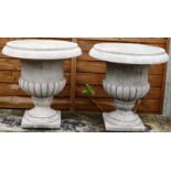 A PAIR OF RECONSTITUTED STONE CAMPAGNA URNS. 1ft 5ins high.