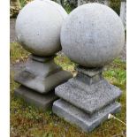 A PAIR OF RECONSTITUTED STONE BALL GATEPOST FINIALS. 1ft 9ins high.
