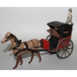 A CIRCA 1900 FRENCH PAINTED CLOCKWORK TINPLATE HORSE AND CAB 9ins long.