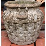 A RECONSTITUTED STONE CIRCULAR GARDEN URN of Celtic design. 1ft 3ins high.