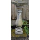 A RECONSTITUTED STONE BALUSTER COLUMN with square top and base. 2ft 11ins high.