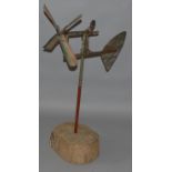 AN EARLY 20TH CENTURY AMERICAN WHIRLIGIG with under stamp on a wooden base.