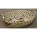 A FINE 18TH CENTURY CHELSEA BASKET painted with fruit and winged insects.
