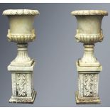 A GOOD PAIR OF CARVED WHITE MARBLE TWO HANDLED CAMPAGNA URN SHAPED VASES ON STANDS, with egg and