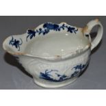 AN 18TH CENTURY WORCESTER CREAM BOAT, painted in blue with two men in an oriental landscape in a