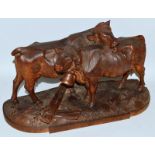 A SUPERB 19TH CENTURY BLACK FOREST CARVED WOOD GROUP OF TWO COWS, one licking the others back. 16ins