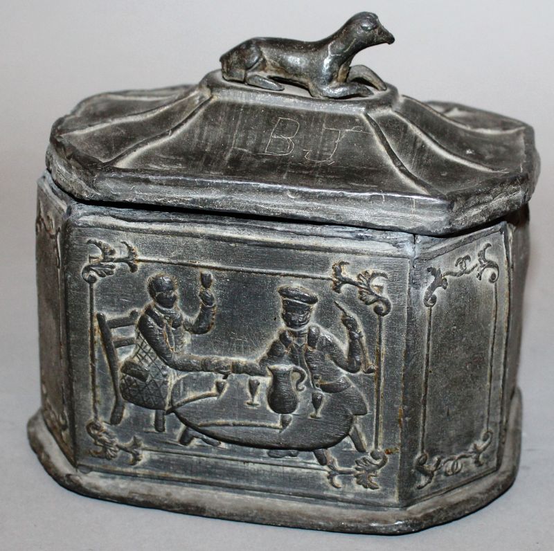 AN OCTAGONAL BOX AND COVER, the pagoda shaped lid with a reclining dog handle, the sides with two