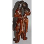 A CARVED WOODEN TRIBAL DOUBLE FIGURE. 7.5ins high.