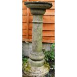 A RECONSTITUTED STONE BIRD BATH with circular column and base. 3ft 1ins high.