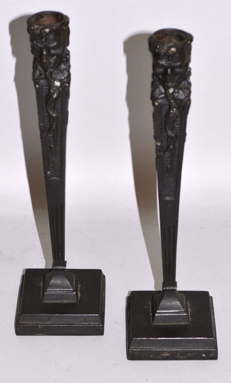 A PAIR OF RUSSIAN CAST IRON CANDLESTICKS decorated with dragons on square bases Mark in Cyrillic 9.