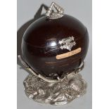 A GOOD COCONUT SOUVENIR FROM MAURITIUS with shell mounted plate handle and base 5.5ins high.
