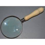 A GOOD MAGNIFYING GLASS with turned ivory handle.