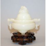 A CHINESE JADE-LIKE TRIPOD CENSER & COVER, together with a fitted wood stand, the sides with