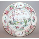 A CHINESE YONGZHENG PERIOD FAMILLE ROSE PORCELAIN PLATE, painted to its centre with two figures in a