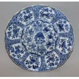 A CHINESE KANGXI PERIOD BLUE & WHITE MOULDED PORCELAIN PLATE, circa 1700, painted with a profusion