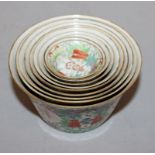 AN UNUSUAL SET OF TEN LATE 19TH CENTURY CHINESE FAMILLE ROSE GRADUATED BOWLS, each painted with