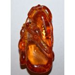 A SMALL 19TH/20TH CENTURY CHINESE AMBER-TYPE CARVING OF A SQUIRREL AMIDST GOURDS, one eye inlaid 2.