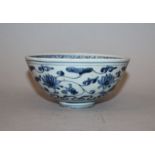 A 16TH CENTURY CHINESE MING DYNASTY BLUE & WHITE PORCELAIN BOWL, the rounded exterior sides