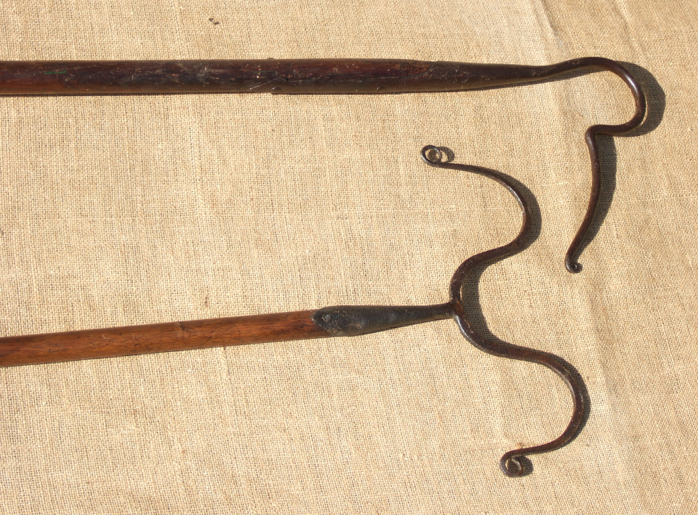 A SHEEP LEG CROOK, AND A DIP HOOK. Both 19th century. The 2m long dip hook doubles as a neck crook