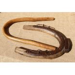 A WOODEN  BULLOCK COLLAR AND AN OX BOW 19th century.