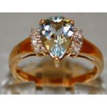 A GOOD LIGHT BLUE TEARDROP AND DIAMOND RING set in 9ct gold.