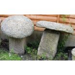 A PAIR OF CARVED STADDLE STONES with square bases. 1ft 8ins high.