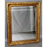 A BEVELLED MIRROR in a moulded frame. 3ft 6ins x 2ft 5ins.